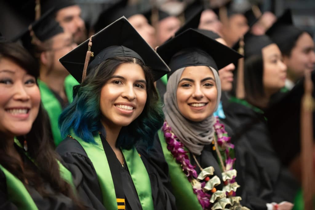 Students at graduation wearing their cap and gown