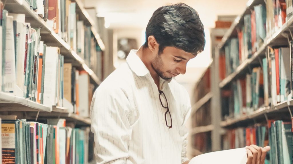 Student reading a book in the library